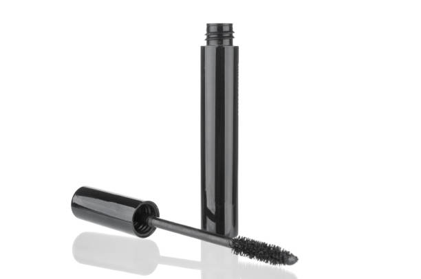 Isolated mascara on neutral backfround. Open with brush, black. Cosmetics and self care concept