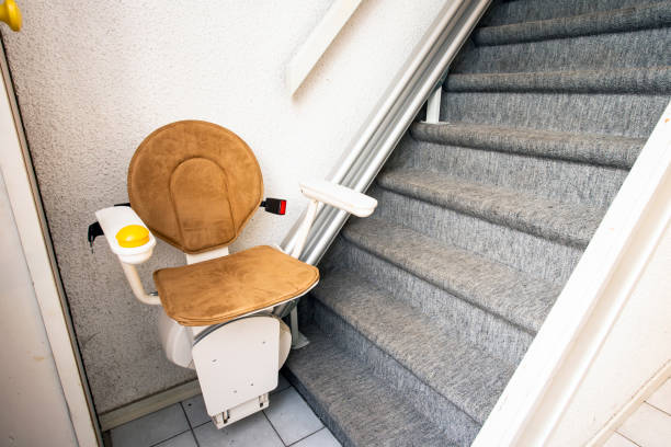 istock Automatic stair lift on staircase taking elderly people and disabled persons up and down in a house 1185673876