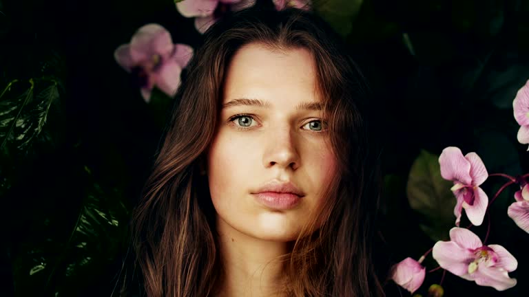 Beautiful girl among the plants and flowers of the archidea.