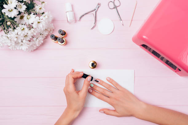 istock Top view woman paints nails 1185675043