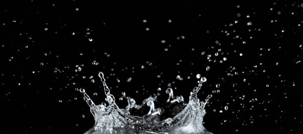 istock Water splash and drops isolated on black background. 1185675358
