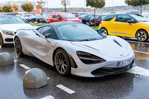 Moscow, Russia - October 9, 2019: White McLaren 720S in the parking lot. Under rain