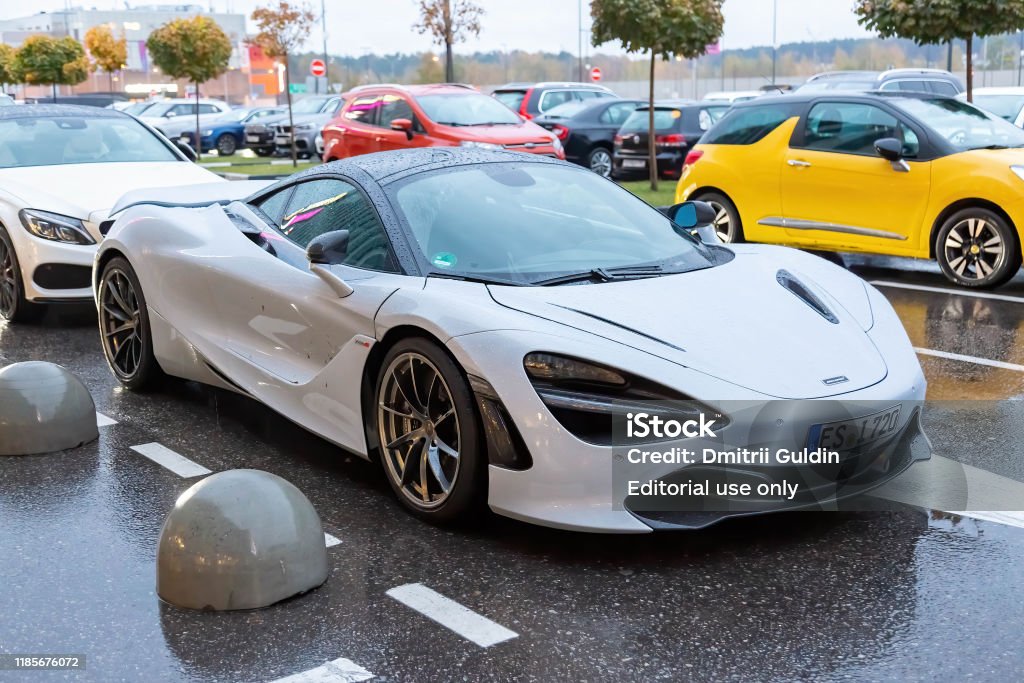 White McLaren 720S in the parking lot. Under rain Moscow, Russia - October 9, 2019: White McLaren 720S in the parking lot. Under rain McLaren Automotive Stock Photo