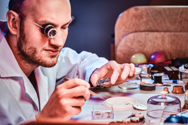 istock Mature clockmaster is fixing old watch for a customer at his busy repairing workshop 1185678060