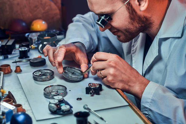istock Expirienced clockmaster is fixing old watch for a customer at his repairing workshop 1185679426