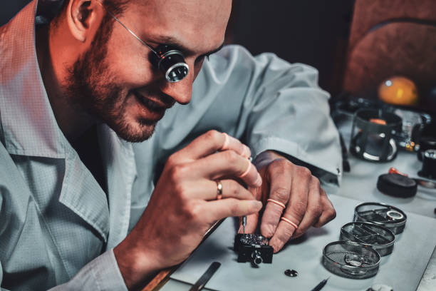 istock Expirienced clockmaster is fixing old watch for a customer at his repairing workshop 1185679567