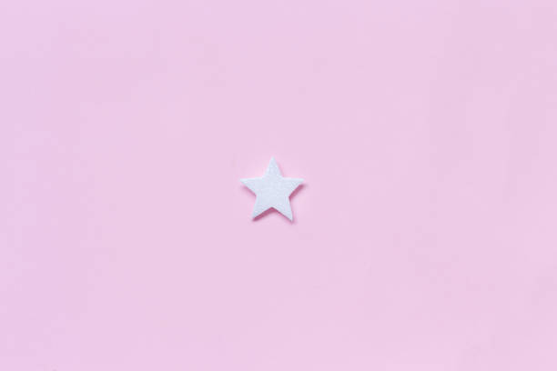 istock White Christmas star on a light pink background 1185679985