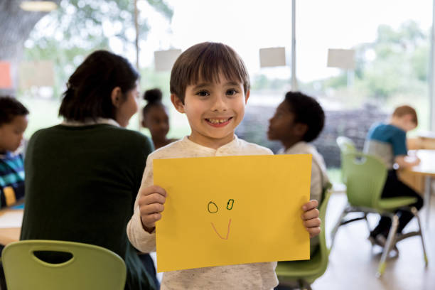 istock Proud kindergarten student shows off his artwork 1185682028