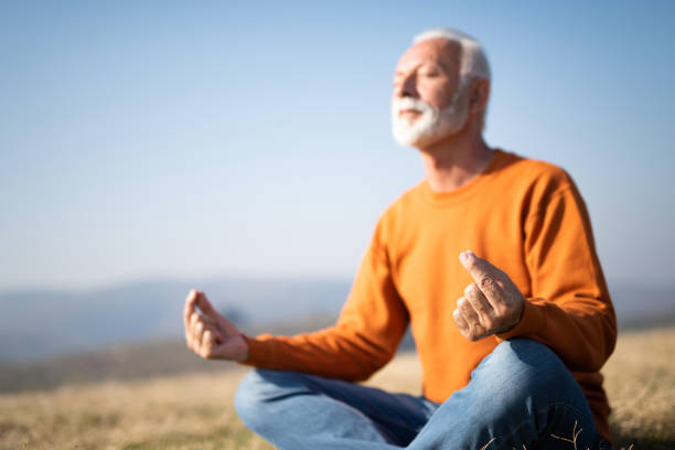istock Senior man meditating in nature. 1185682712