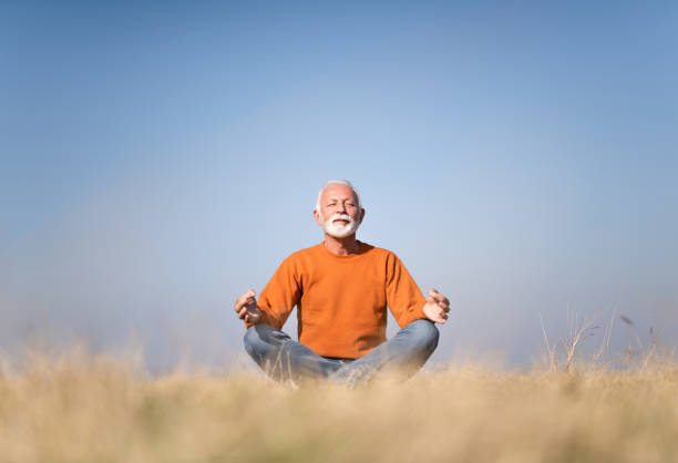 istock Senior man meditating in nature. 1185682930