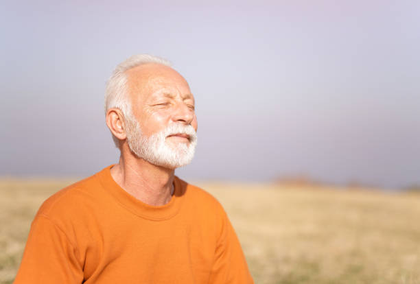 istock Senior man meditating in nature. 1185682954