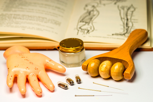 acupuncture needles with hand model, massage roller, pills, ointment and textbook\