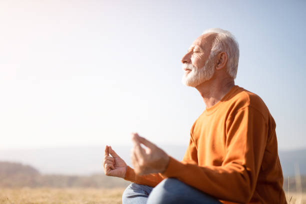 istock Senior man meditating in nature. 1185683536