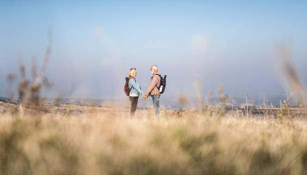 istock Inseparable senior couple hiking in nature together. 1185683876