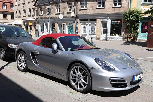 Silver Porsche Boxster roadster sports convertible car parked in Germany. There were 45.8 million cars registered in Germany (as of 2017).