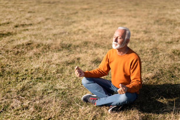 istock Senior man meditating in nature. 1185684458