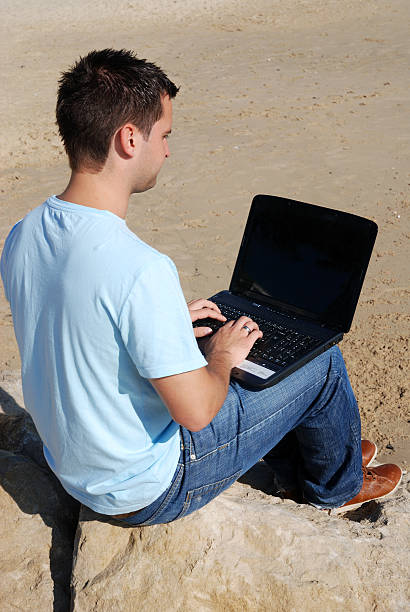 Man working on laptop stock photo