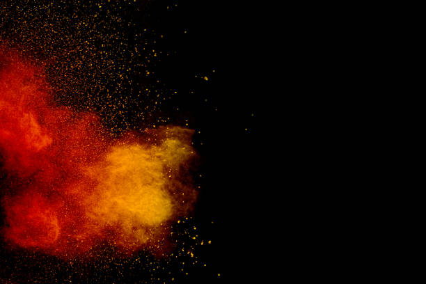 istock Orange red  powder explosion on black background.Orange red color dust splash clouds. 1185687072