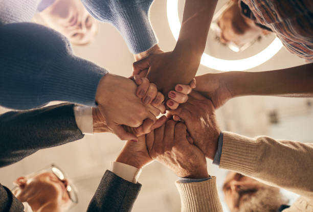 istock Group of people holding hands 1185692635