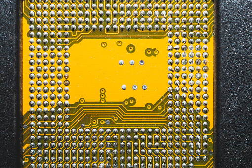 Processor pins macro. computer motherboard close up. CPU pins on a circuit board. micro elements of computer central processor unit. modern technologies abstract background