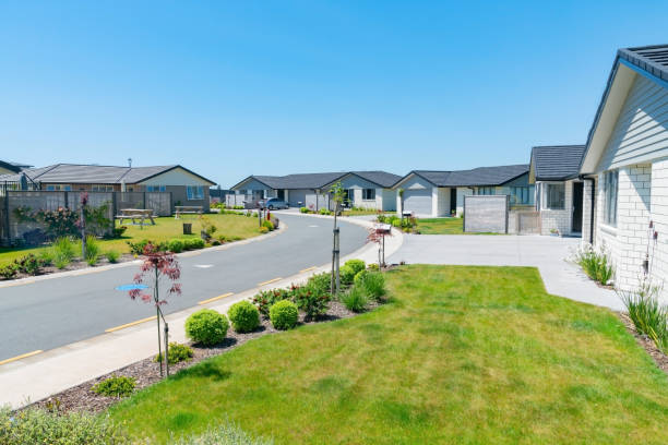istock New subdivision street with uniform homes. 1185692963