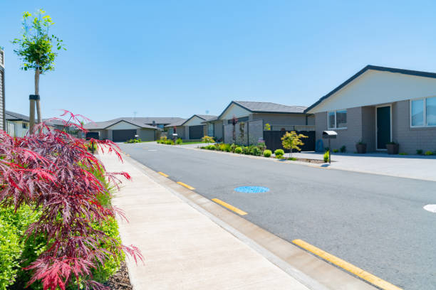 istock New subdivision street with uniform homes. 1185693080