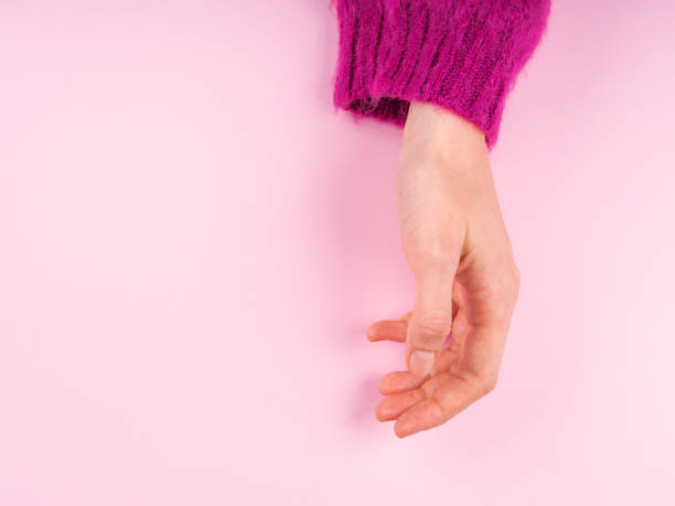 istock Female hand in magenta sweater on pink 1185695447