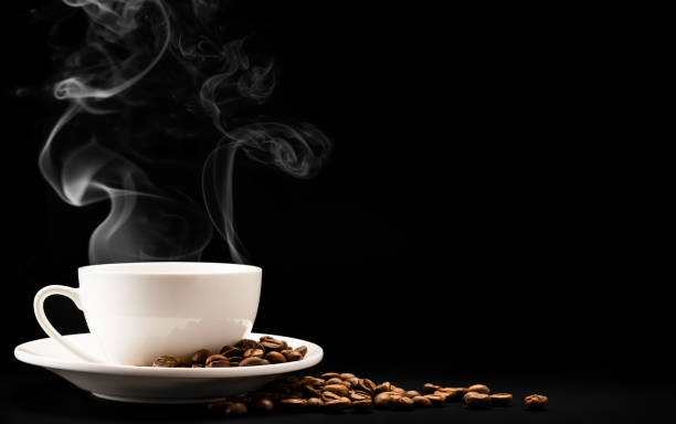 istock Cup coffee with steam and beans on a black background, a place for text. 1185703001
