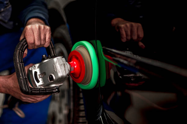 Working on a quarter panel with a portable handheld polisher