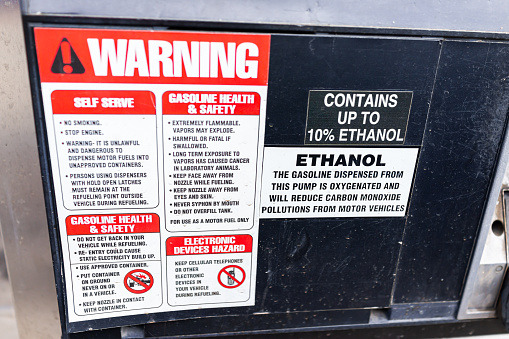Durango, USA - September 7, 2019: Sign in Colorado Peerless Tyre gas station for warning contains up to 10 percent ethanol with red label and text at pump