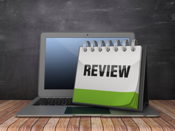 istock REVIEW Calendar with Computer Laptop on Chalkboard Background - 3D Rendering 1185710382