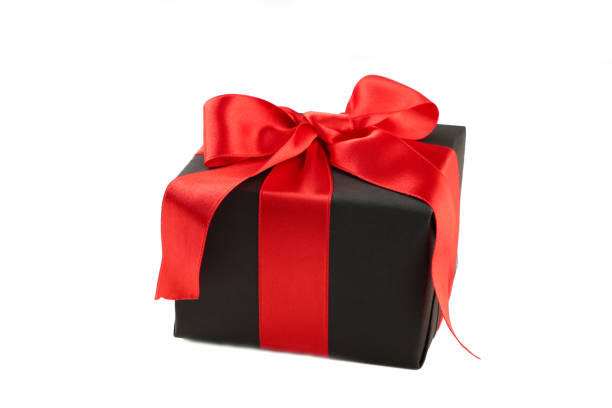 istock Black gift box with red ribbon and bow isolated on white background. 1185710421