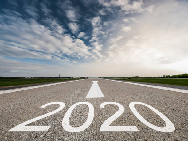 istock Driving to upcoming 2020 on Empty asphalt road 1185710631