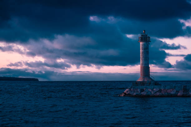istock Stunning long exposure landscape lighthouse at sunset with calm. Water 1185710887