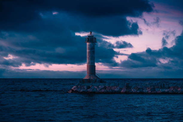 istock Stunning long exposure landscape lighthouse at sunset with calm. Water 1185711518