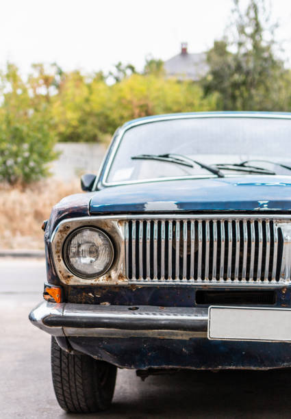 istock Vertical front view of old dark blue rusty car vehicles with headlight 1185711927