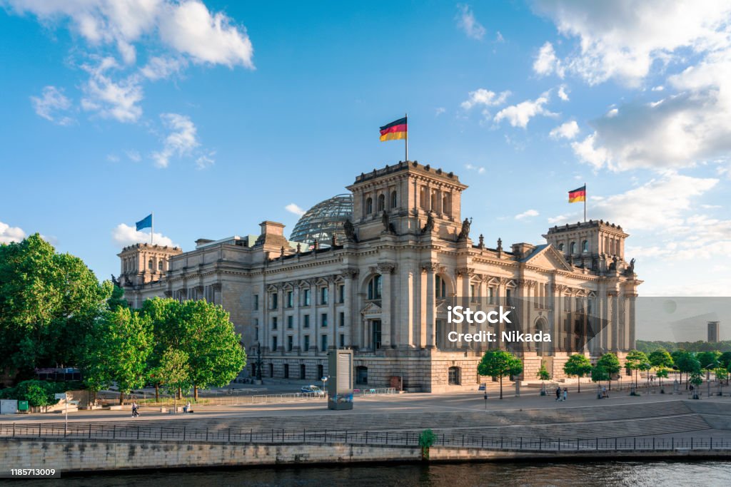 Reichstag and government district in Berlin, Germany Reichstag with german flag, Berlin, Germany Bundestag Stock Photo
