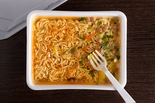 brewed instant noodles in plastic packaging, close-up, top view, junk food, fast food