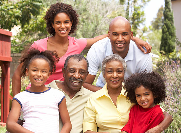 istock Extended Family Group Relaxing In Garden 118571442