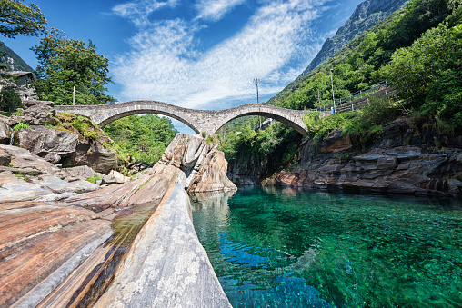 The stone bridge „Ponte dei Salti“ with two arches was built in the 17th century and is a pedestrian bridge over river Verzasca in Lavertezzo in the Swiss canton of Ticino. An international landmark for all tourists. The photography shows no people which is really rare.