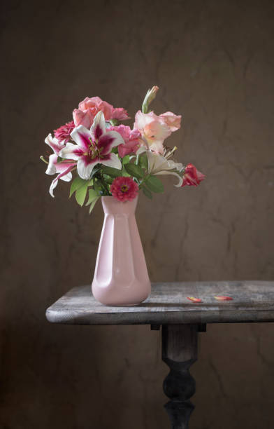 istock still life with summer flowers in vase on dark background 1185716794