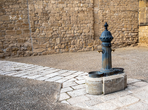Old drinking water pump in the old town Bastida, La Rioja, Spain.