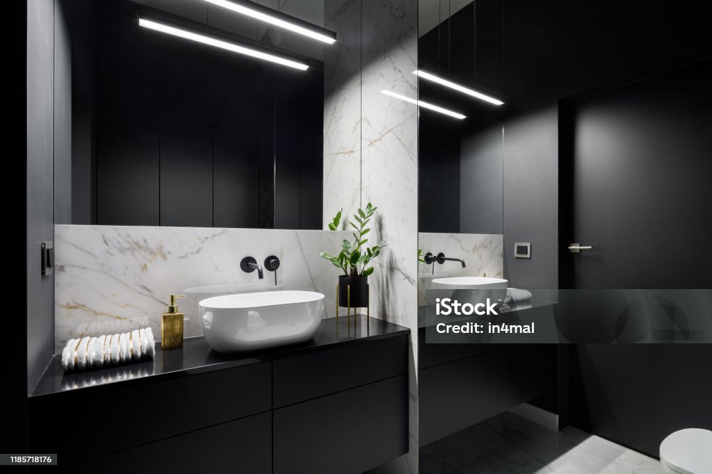 Black bathroom with mirror wall Elegant black bathroom with mirror wall and decorative marble tiles Bathroom Stock Photo