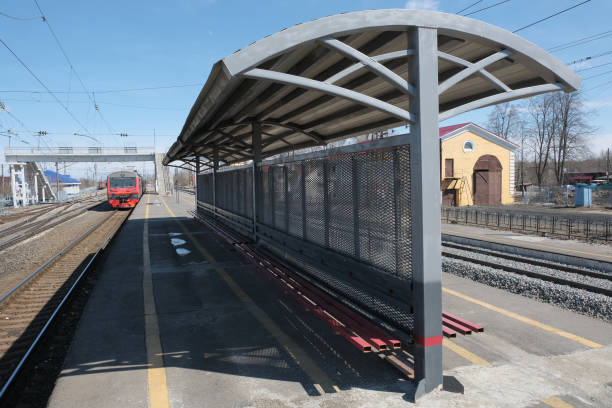 istock view from platform on the station complex with pedestrian overpass and other buildings of railway infrastructure with awning from the weather in the foreground and electric train away 1185719670
