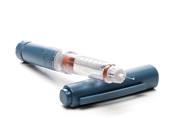 Insulin pen with blue cap and needle stock photo