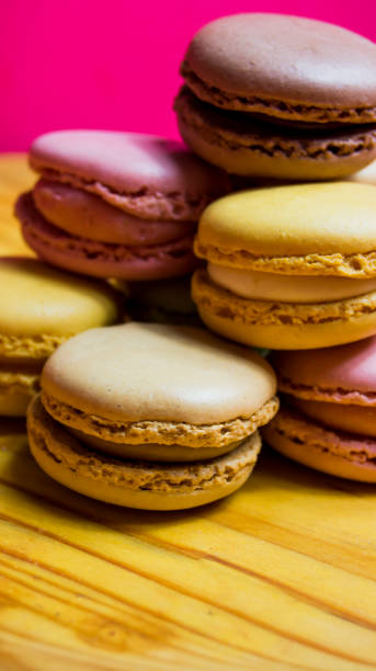 istock Colored macarons isolated on wooden dish, typical French dish 1185723153