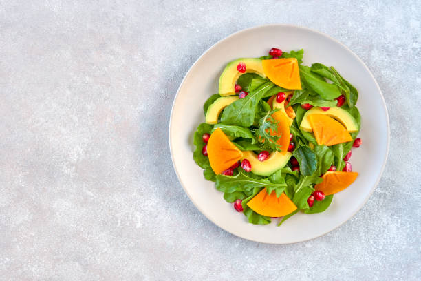 istock Salad with arugula, persimmon, avocado and pomegranate seeds 1185725119