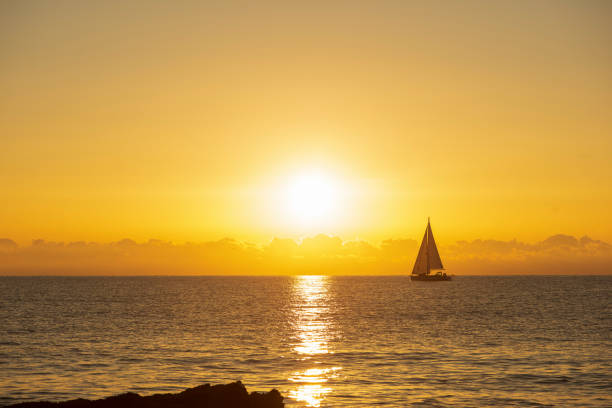 Sailboat sailing at dawn in Alcocebre, Spain