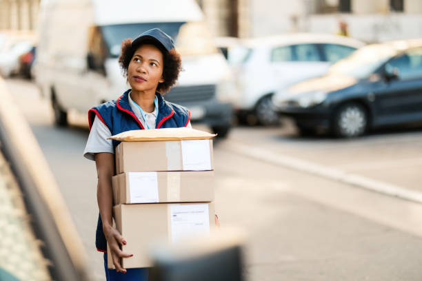 istock Black female courier making delivery in the city. 1185725749
