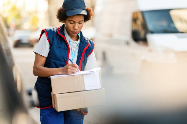 istock African American deliverer filling document while making delivery in the city. 1185725903